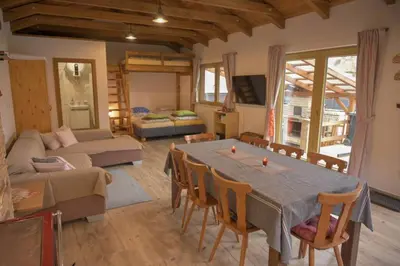 a living room with a table and a couch at Útulný domek v zahradě v Unhošti nedaleko letiště in Unhošť