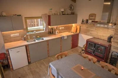 an aerial view of a kitchen with a table and chairs at Útulný domek v zahradě v Unhošti nedaleko letiště in Unhošť