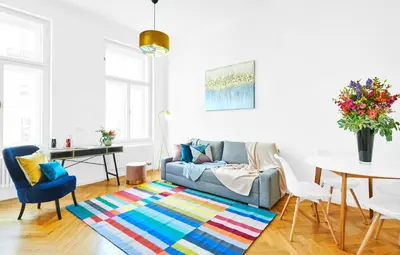 a living room with a couch and a table at Pytloun Bristol Residence Prague in Prague