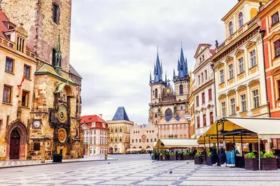 a city street with buildings and a cathedral at Pytloun Bristol Residence Prague in Prague