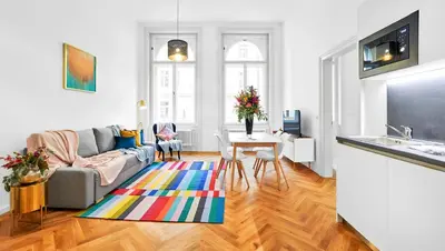 a living room with a couch and a table at Pytloun Bristol Residence Prague in Prague