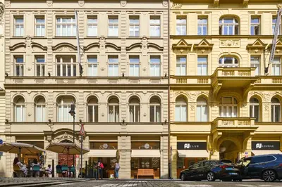 a large building with cars parked in front of it at Pytloun Bristol Residence Prague in Prague