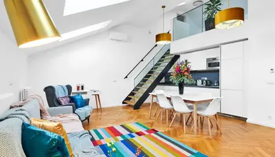 a living room with a couch and a table at Pytloun Bristol Residence Prague in Prague