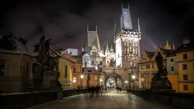 a large building with a clock tower at night at Prague Old Town Liliova Garden in Prague