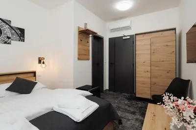 a bedroom with a bed and a wooden door at Prague Old Town Liliova Garden in Prague