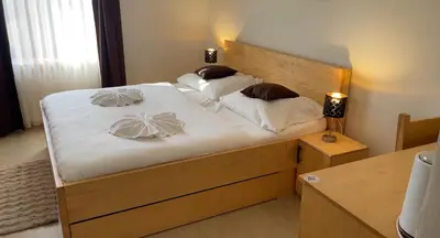 a bedroom with a large bed with white sheets and pillows at Hotel & wellness Hejtmanka in Mladá Boleslav