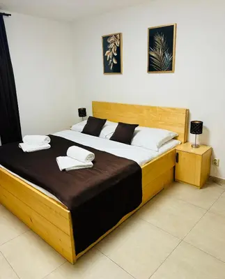 a bedroom with a large bed with two towels on it at Hotel & wellness Hejtmanka in Mladá Boleslav