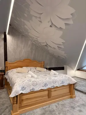 a bedroom with a bed with a large painting on the wall at Hotel & wellness Hejtmanka in Mladá Boleslav