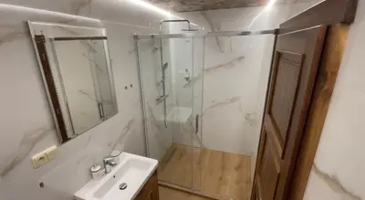 a bathroom with a glass shower and a sink at Hotel & wellness Hejtmanka in Mladá Boleslav