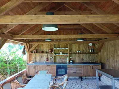 a kitchen with wooden walls and a table and chairs at Bohemica Apartman 4 in Kouřim