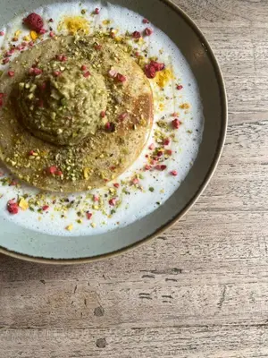 a plate of food with pesto and sprinkles on it at Time Cafe & Penzion in Příbram