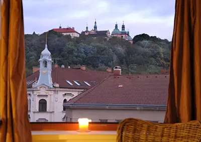 a view of a church from a window with a candle at Time Cafe & Penzion in Příbram