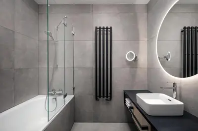 a bathroom with a tub and a sink and a mirror at STAGES HOTEL Prague, a Tribute Portfolio Hotel in Prague