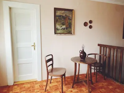 a room with a table and chairs and a door at Vila Lumír in Poděbrady