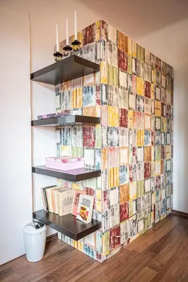 a wall covered in photos and books in a room at Vila Lumír in Poděbrady