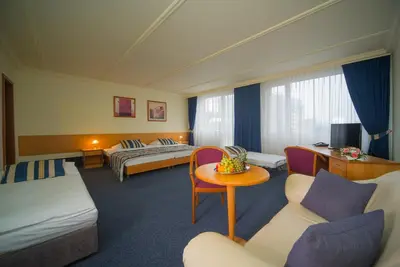 a hotel room with two beds and a table at TOP HOTEL Praha in Prague