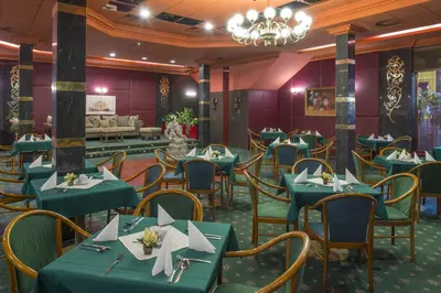 a dining room with green tables and chairs at TOP HOTEL Praha in Prague