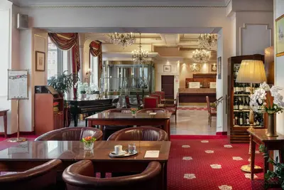 a restaurant with tables and chairs and a bar at Ambassador Zlata Husa in Prague