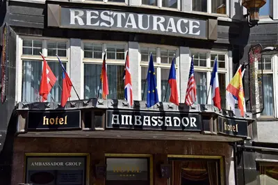 a bunch of flags on the front of a building at Ambassador Zlata Husa in Prague