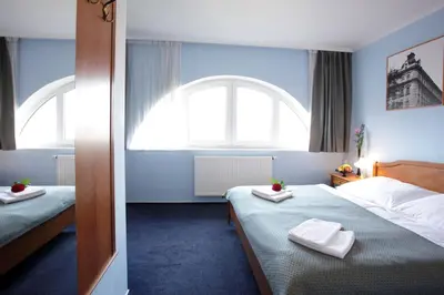 a hotel room with two beds and a window at Anna Hotel in Prague