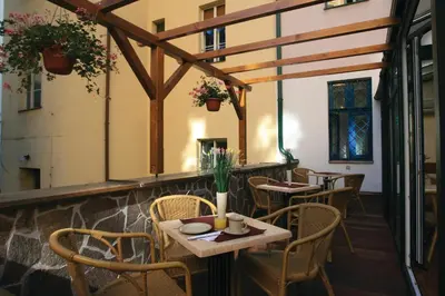 a restaurant with tables and chairs on a patio at Anna Hotel in Prague