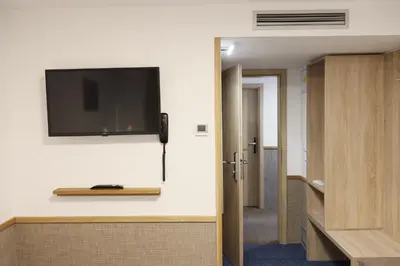 a room with a flat screen tv on a wall at Botel Racek in Prague