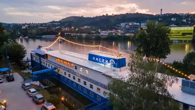 a view of a bridge over a river with a building at Botel Racek in Prague