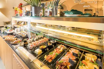 a buffet line with many different types of food at Best Western Hotel Moran in Prague