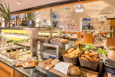 a buffet with cheese and other foods on a table at Best Western Hotel Moran in Prague