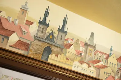 a painting of a town on top of a wall at Union Hotel Prague in Prague