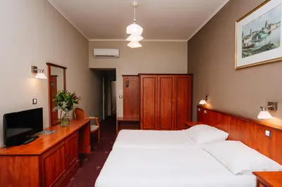 a bedroom with two beds and a television at Union Hotel Prague in Prague