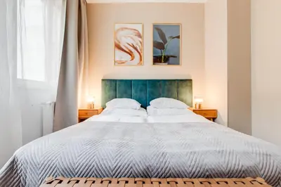 a bedroom with a large white bed with two lamps at Hotel Andante in Prague