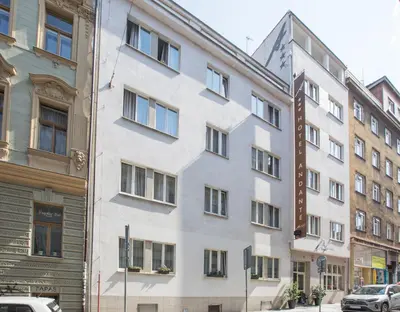 a white building with windows on a city street at Hotel Andante in Prague