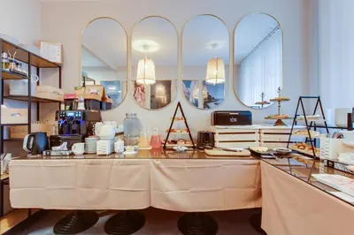 a store with a table with mirrors on the wall at Hotel Andante in Prague