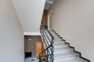 a staircase in a building with a metal railing at Hotel Andante in Prague