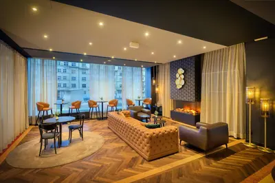 a living room with a couch and a table at Diplomat Hotel Prague in Prague