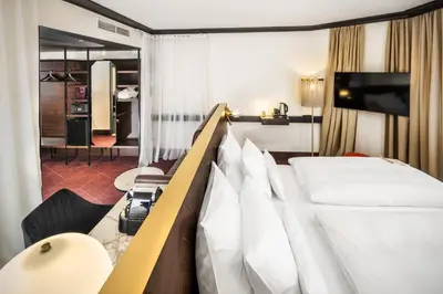 a hotel room with a bed and a television at Diplomat Hotel Prague in Prague