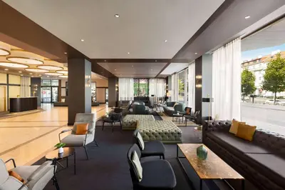 a lobby with couches and chairs in a building at Diplomat Hotel Prague in Prague