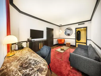 a living room with a table and a couch at Diplomat Hotel Prague in Prague