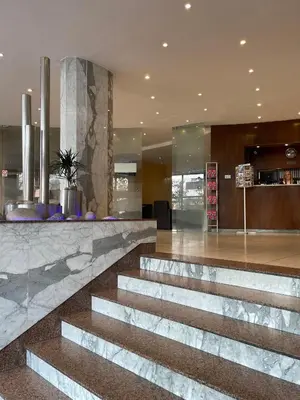 a lobby with a staircase in a building at Luxury Family Hotel Bílá Labuť in Prague