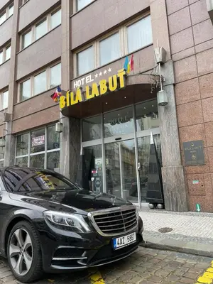 a black car parked in front of a building at Luxury Family Hotel Bílá Labuť in Prague