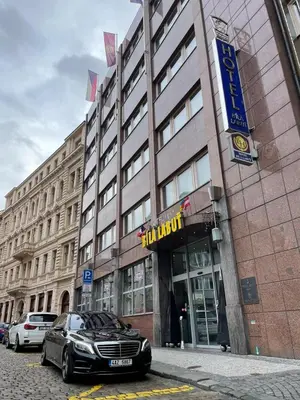 a black car parked in front of a building at Luxury Family Hotel Bílá Labuť in Prague