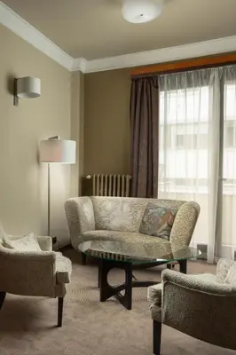 a living room with a couch and two chairs at Jalta Boutique Hotel in Prague