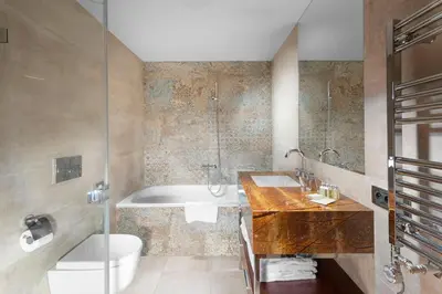 a bathroom sink with a shower head and two bottles of soap at Jalta Boutique Hotel in Prague
