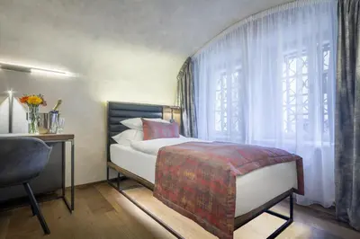 a bedroom with a bed and a window at Hotel Waldstein in Prague