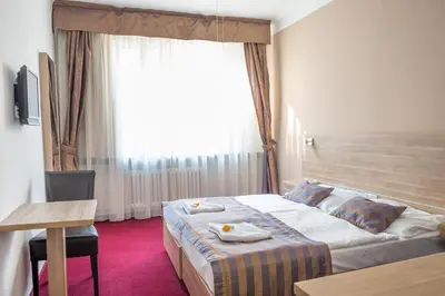 a hotel room with a bed and a window at Hotel Meda of Museum Kampa in Prague