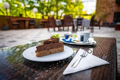 a piece of cake on a plate on a table at Expo Hotel in Prague