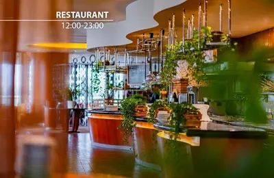 a dining room with tables and chairs in a restaurant at Grand Hotel Prague Towers - Czech Leading Hotels in Prague