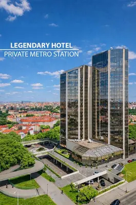 a woman sitting at a piano in a hotel lobby at Grand Hotel Prague Towers - Czech Leading Hotels in Prague