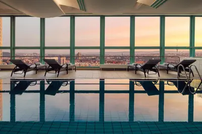 a swimming pool with chairs and a view of the city at Panorama by Verdi Hotels in Prague
